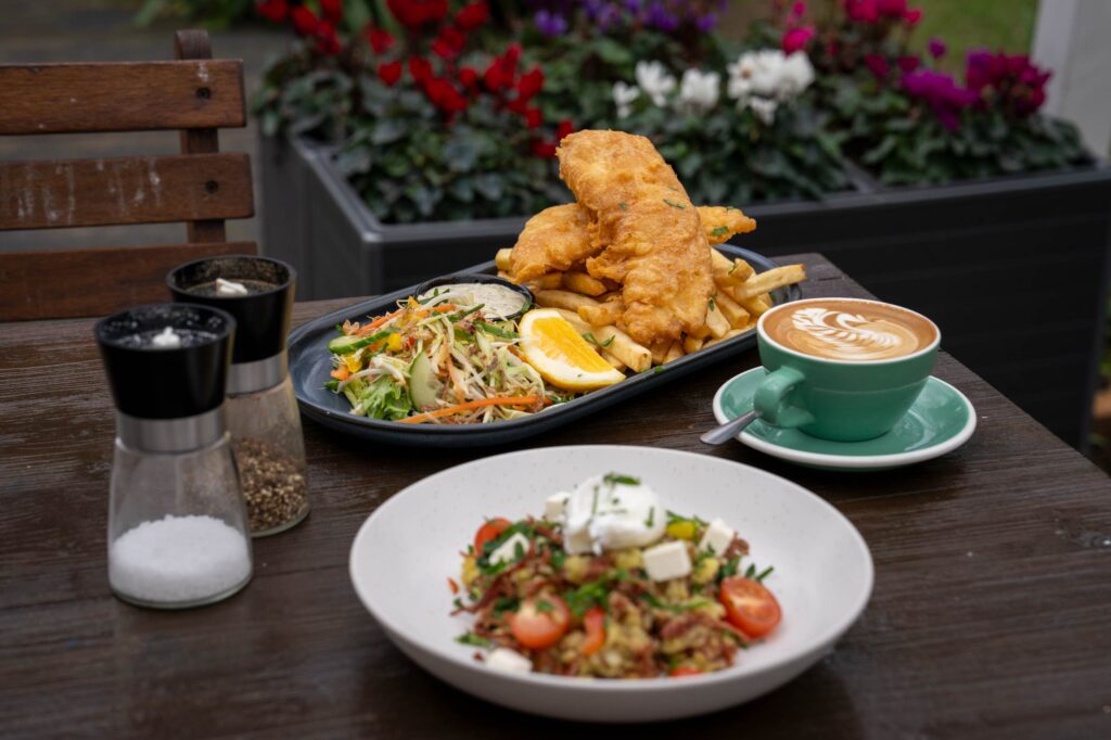 A full table spread of dishes at The Collins including Big G's Hash, and Snapper & Chips